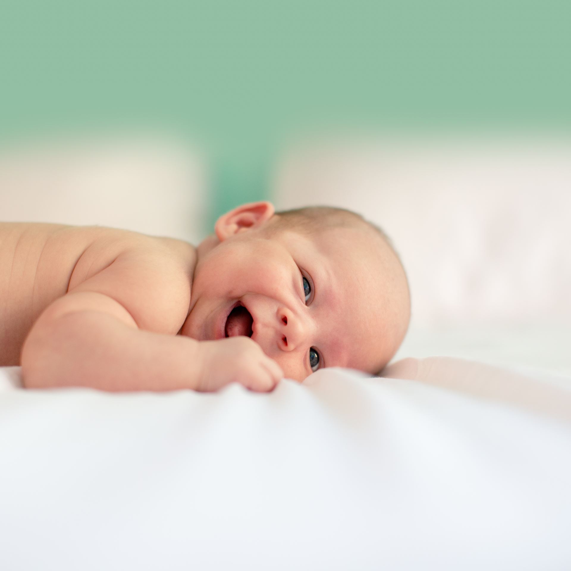 a baby lying on a bed